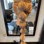 Bubble braid hairstyle created on mannequin by apprentice Chloe at Rejuvenation Spa.