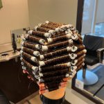 Mannequin head with a full perm wrap in even, geometric sections - back view
