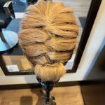 Mannequin styled in a polished special occasion style during Week 10 practice.