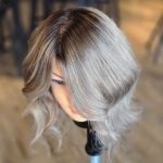 \A top-down view of a mannequin’s hair showing a smooth transition from a deep brunette base to multidimensional ashy blonde tones.